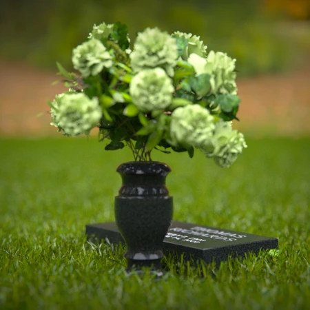 Compact headstones featuring photo inlays and floral vases for memorials.