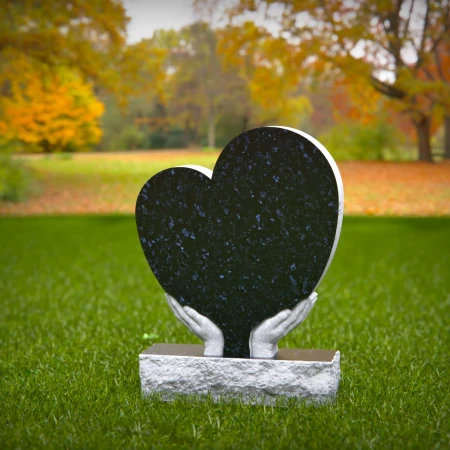 Comforting headstones with sculpted hands gently cupping heart