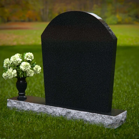 Arched granite headstones with elegant form and flower vase.