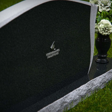 Elegant contoured headstones with flower vase for refined tribute.