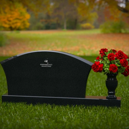 Contoured granite headstones with single flower vase for tribute.
