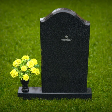 Elegant single granite headstones with curved top and flower vase.