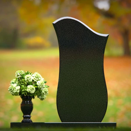 Contemporary granite headstones with unique curved design and vase.