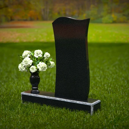 Modern curved granite headstones with engraved detailing for tribute.