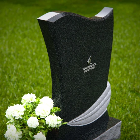 Elegant granite headstones with flowing contoured design and flower vase.