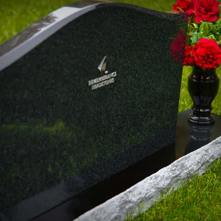 Waved granite headstones with single flower vase for graceful tribute.