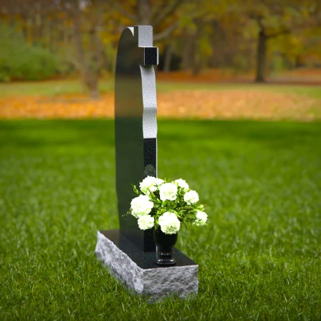 Graceful asymmetrical granite headstones with cross, symbolizing faith and remembrance.