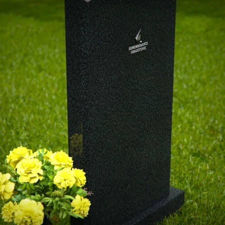 Elegant single granite headstones with curved top and flower vase.