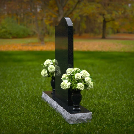 Elegant upright headstones with floral arrangement for timeless tribute.