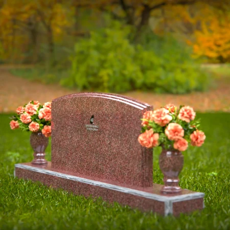 Dual vase headstones with arched design honoring shared memories.
