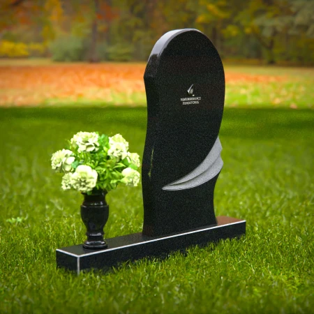 Contemporary headstones with curved artistic design and floral vase.