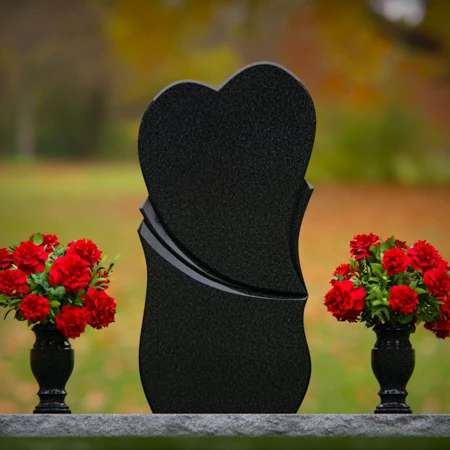 Unique dual heart headstones with twin flower vases for memorials.