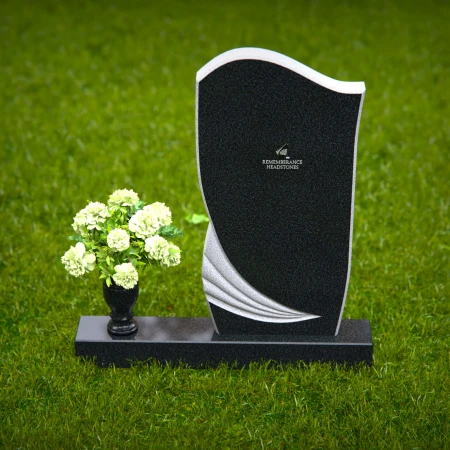 Artistic headstones with unique curved design and flower vase.