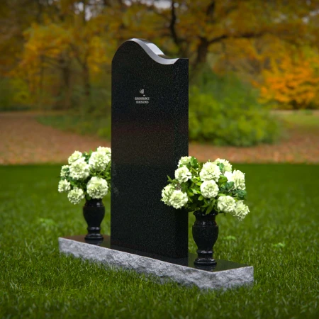 Elegant upright headstones with floral arrangement for timeless tribute.