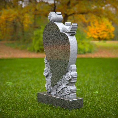 Doves rise around heart shape etched with floral memory in grave markers