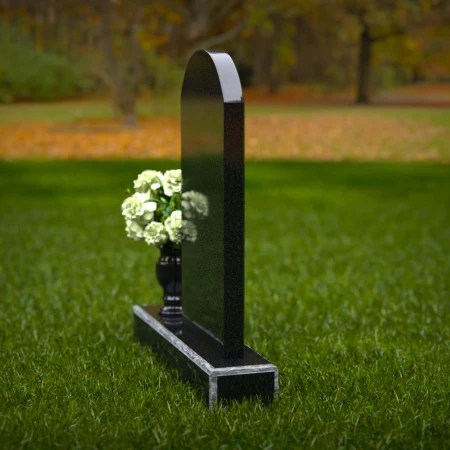 Classic arched headstones with a single flower vase for tribute.