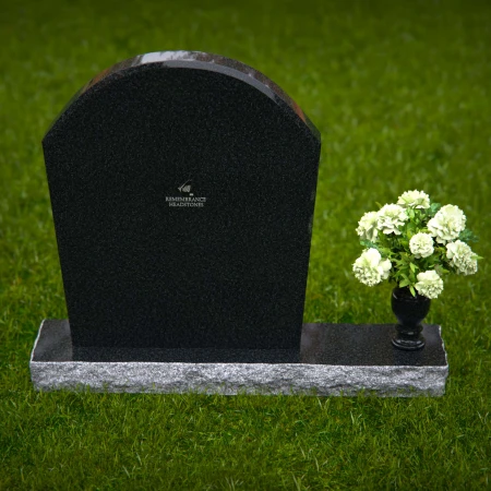 Arched granite headstones with elegant form and flower vase.