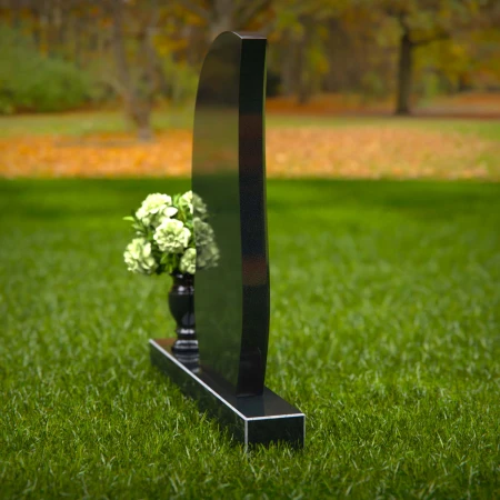 Modern curved headstones with single flower vase for memorials.