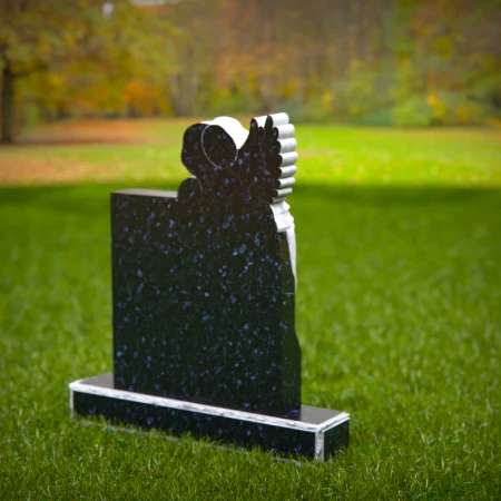 Carved children’s headstones with quiet angel watching over