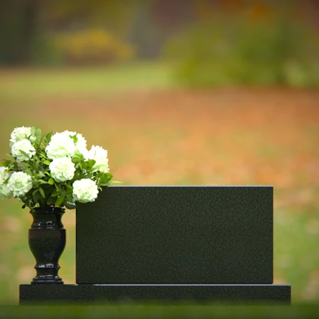 Elegant headstones featuring custom memorial designs and flower vases.