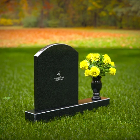 Classic arched granite headstones with polished vase tribute.