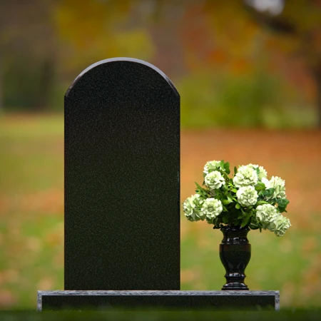 Classic arched headstones with a single flower vase for tribute.