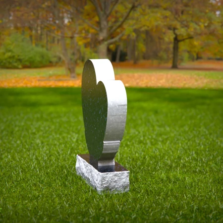 Comforting headstones with sculpted hands gently cupping heart