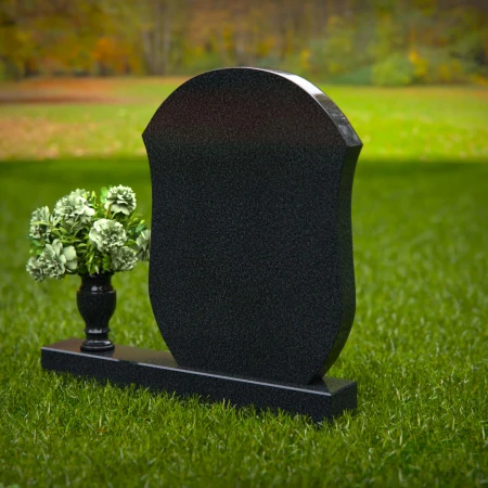 Unique granite headstones with rounded shield design and flower vase.