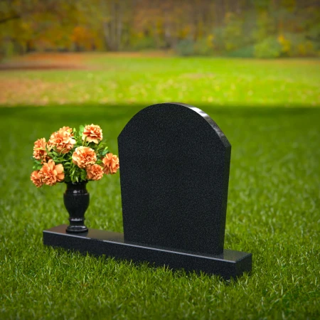 Classic arched granite headstones with single flower vase tribute.