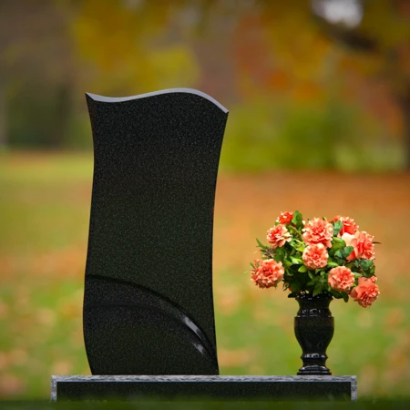 Modern curved granite headstones with engraved detailing for tribute.