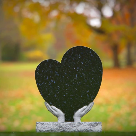 Comforting headstones with sculpted hands gently cupping heart