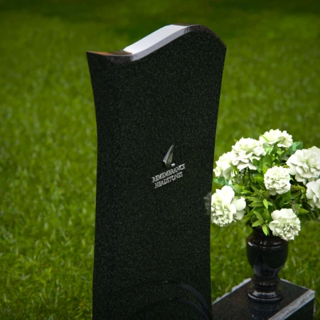 Modern curved granite headstones with engraved detailing for tribute.